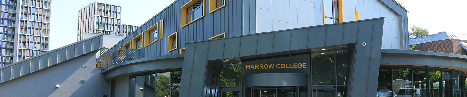Exterior of Harrow College Harrow on the Hill campus showing the grey buildings with yellow trim. 