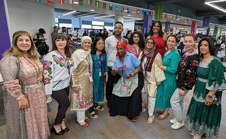 Staff from Harrow College dressed in their national cultural clothing for the Fusion Fiesta - Cultural Day. Posing for a group photo. 