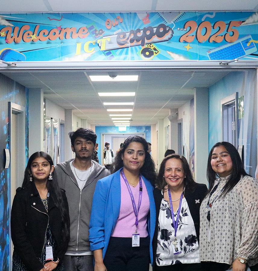 ICT Harrow staff and students standing in a group and smiling at the camera below a sign that says 'Welcome to our ICT expo 2025'.