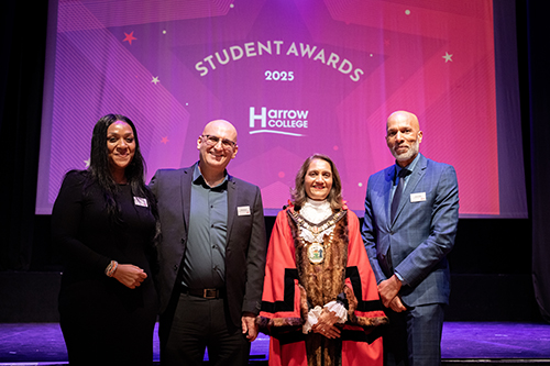 Kelly Ocloo (Assistant Principal), Sultan Soukani (Assistant Principal), Councillor Anjana Patel and Clive Hodge (Harrow College Principal) posing for a group photo in front of the stage at the 2025 Harrow College Student Awards.